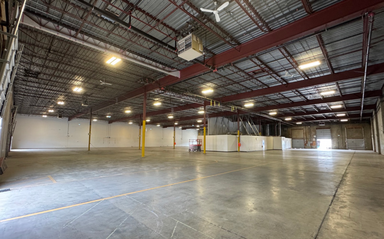 Open warehouse interior at 403 East Kent Avenue North showing 23 foot clear height and existing office improvements